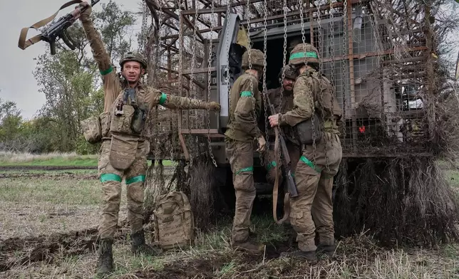 In this photo provided by Ukraine's 65th Mechanized Brigade press service, soldiers react as they came back after a long time mission on the frontline in the Zaporizhzhia region, Ukraine, Monday, Oct. 19, 2026. (Andriy Andriyenko/Ukraine's 65th Mechanized Brigade via AP)
