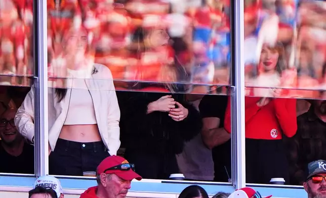 WNBA player Caitlin Clark, from left, Este Haim, and Taylor Swift watch play between the Los Angeles Chargers and Kansas City Chiefs during the first half of an NFL football game in Kansas City, Mo., Sunday, Oct. 18, 2026. (AP Photo/Charlie Riedel) Adds Este Haim
