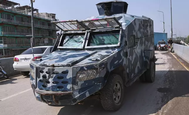 A police armored personnel carrier patrol on a barricaded road to maintain law and order situation following the Pakistani president declared a state of emergency in northwestern Khyber Pakhtunkhwa province and suspended its government, in Peshawar, Pakistan, Monday, Oct. 12, 2026. (AP Photo/Muhammad Zubair)