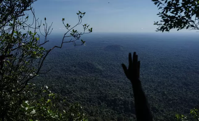 A member of Saamaka community patrols in Ebbatop, Suriname, Sunday, Sept. 27, 2026. (AP Photo/Ivan Valencia)