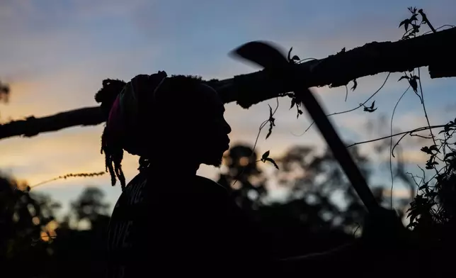 Dennis Adipi, a member of the Saamaka community, makes a camp to spend the night while patrolling in Ebbatop, Suriname, Saturday, Sept. 26, 2026. (AP Photo/Ivan Valencia)