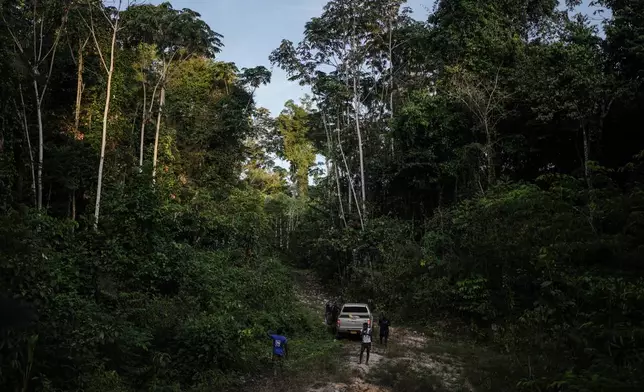 Members of the Saamaka community patrol in Ebbatop, Suriname, Saturday, Sept. 26, 2026. (AP Photo/Ivan Valencia)