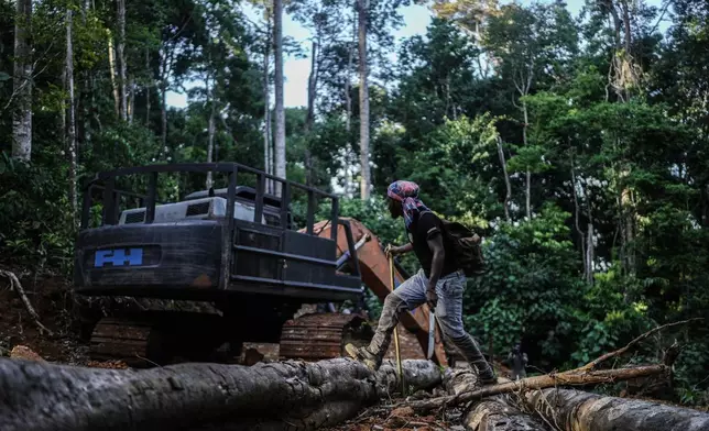 Navaldo Vola, a member of the Saamaka community, checks an abandoned excavator from illegal miners in Ebbatop, Suriname, Sunday, Sept. 27, 2026. (AP Photo/Ivan Valencia)