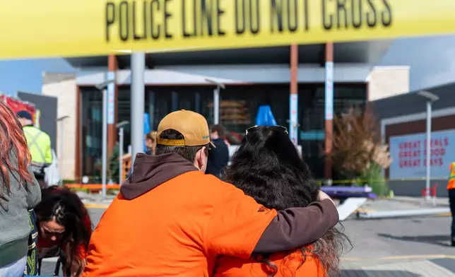 Attendees of a Truth and Reconciliation Event console each other outside the entrance of Tsawwassen Mills Mall, after a vehicle drove through the crowd in Tsawwassen, British Columbia, Canada, on Wednesday, Sept. 30, 2026. (Rich Lam/The Canadian Press via AP)