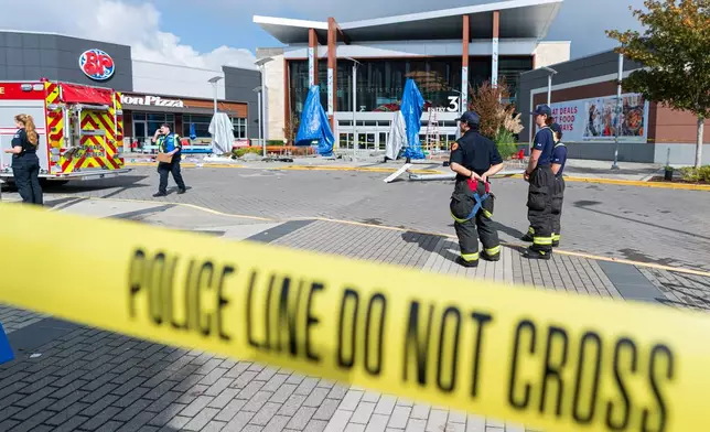 Emergency personnel respond after a vehicle drove through a Truth and Reconciliation event at the Tsawwassen Mills Mall in Tsawwassen, B.C., on Wednesday, Sept. 30, 2026. (Rich Lam/The Canadian Press via AP)