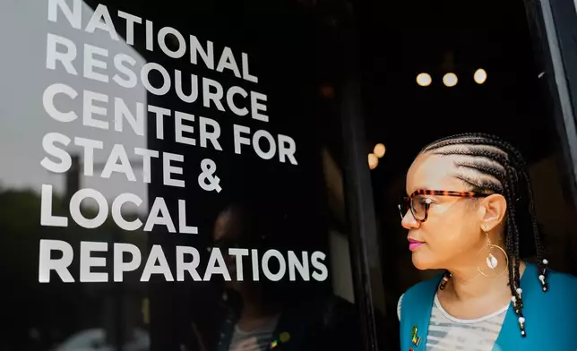 Founder and Executive director of FirstRepair, Robin Rue Simmons looks at a window at her office Monday, Aug. 10, 2026, in Evanston, Ill. (AP Photo/Nam Y. Huh)
