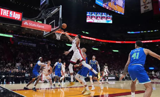 Miami Heat forward Giannis Antetokounmpo (7) scores during the first half of an NBA basketball game against the Minnesota Timberwolves, Wednesday, Oct. 21, 2026, in Miami. (AP Photo/Rebecca Blackwell)