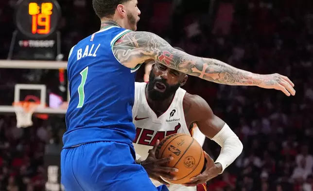 Miami Heat guard Tim Hardaway Jr. (10) clashes with Minnesota Timberwolves guard LaMelo Ball (1) during the first half of an NBA basketball game, Wednesday, Oct. 21, 2026, in Miami. (AP Photo/Rebecca Blackwell)