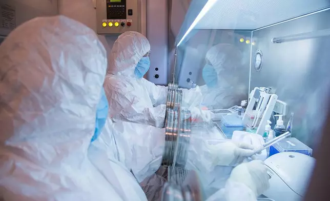 This undated photo released in 2019 by the Irkutsk Anti-Plague Research Institute of Siberia and Far East, shows the institute workers in a lab. (The Irkutsk Anti-Plague Research Institute of Siberia and Far East via AP) ADDITION: adding photo was released in 2019
