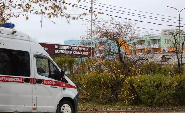 An ambulance drives past the medical center for treating infectious diseases, center, in Shelekhov, outside Irkutsk, Russia, on Thursday, Oct. 8, 2026. (AP Photo)