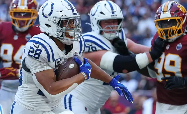 Indianapolis Colts running back Jonathan Taylor (28) runs into the end zone to scores his side's second touchdown during an NFL football game against Washington Commanders in London, Sunday, Oct. 4, 2026. (AP Photo/Ian Walton)