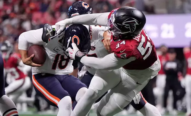 Atlanta Falcons defensive end Brandon Dorlus (54) sacks Chicago Bears quarterback Caleb Williams (18) during the first half of an NFL football game in Atlanta, Sunday, Oct. 18, 2026. (AP Photo/Mike Stewart)