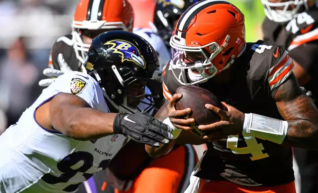 Baltimore Ravens defensive end Calais Campbell (93) sacks Cleveland Browns quarterback Deshaun Watson (4) during the first half of an NFL football game in Cleveland, Sunday, Oct. 18, 2026. (AP Photo/David Richard)
