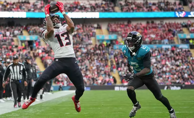 Houston Texans wide receiver Jaylin Noel (13) makes a catch to score a touchdown during an NFL football game against Jacksonville Jaguars in London, Sunday, Oct. 18, 2026. (AP Photo/Kin Cheung)