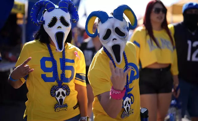 Fans tailgate before an NFL football game between the Los Angeles Rams and the Arizona Cardinals in Inglewood, Calif., Sunday, Oct. 18, 2026. (AP Photo/Gregory Bull)