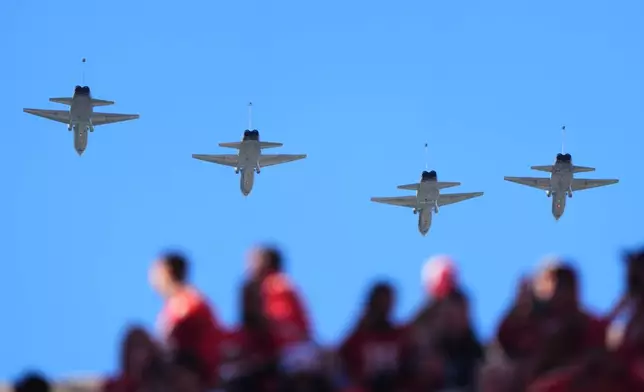 Fans watch a fly over during the first half of an NFL football game between the Los Angeles Chargers and Kansas City Chiefsin Kansas City, Mo., Sunday, Oct. 18, 2026. (AP Photo/Charlie Riedel)