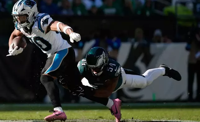 Carolina Panthers running back Chuba Hubbard, left, is tackled by Philadelphia Eagles linebacker Jeremiah Trotter Jr. during the second half of an NFL football game in Philadelphia, Sunday, Oct. 18, 2026. (AP Photo/Matt Slocum)
