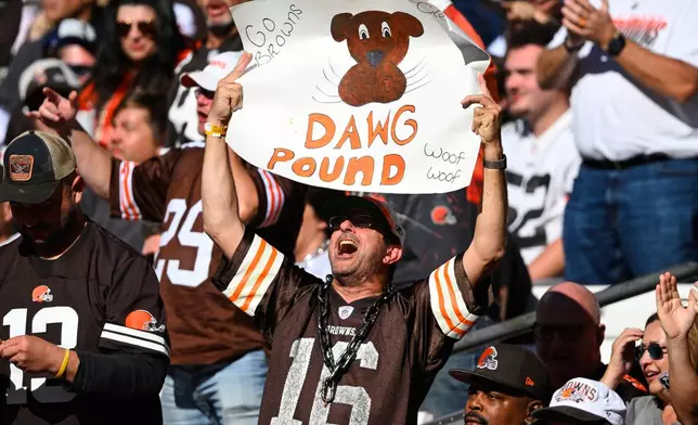 A Cleveland Browns fan raises a sign during the second half of an NFL football game against the Baltimore Ravens in Cleveland, Sunday, Oct. 18, 2026. (AP Photo/David Richard)