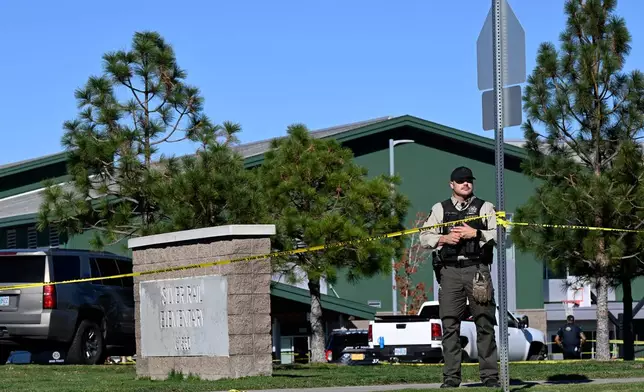 Police tape is placed outside Silver Rail Elementary school, where a shooting took place, on Thursday, Oct. 15, 2026 in Bend, Ore. (AP Photo/Joe Kline)