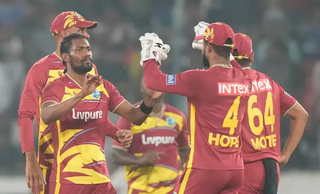 West Indies' Keemo Paul, second left, celebrates the wicket of India's Nitish Kumar Reddy during the fourth T20 cricket match between India and West Indies in Hyderabad, India, Wednesday, Oct. 14, 2026. (AP Photo/Mahesh Kumar A.)