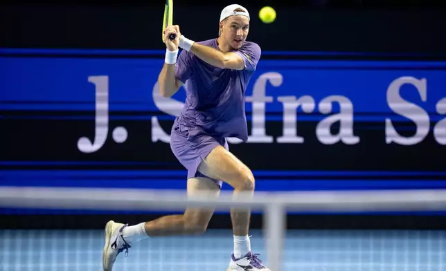 Germany's Jan-Lennard Struff hits a return to Serbia's Novak Djokovic during their match at the Swiss Indoors tennis tournament at the St. Jakobshalle in Basel, Switzerland, Thursday, Oct. 29, 2026. (Claudio Thoma/Keystone via AP)
