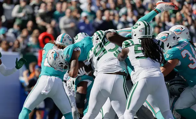 Miami Dolphins running back Ollie Gordon II dives for a first down in the first half of an NFL football game against the New York Jets in East Rutherford, N.J., Sunday, Oct. 25, 2026. (AP Photo/Adam Hunger)