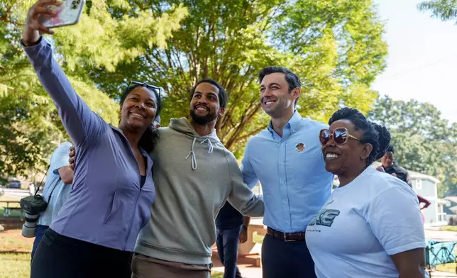 Sen. Jon Ossoff, D-Ga., poses for a photo with supporters after voting early at the Bessie Branham Recreation Center in Atlanta, Tuesday, Oct. 13, 2026. (Ben Hendren/Atlanta Journal-Constitution via AP)