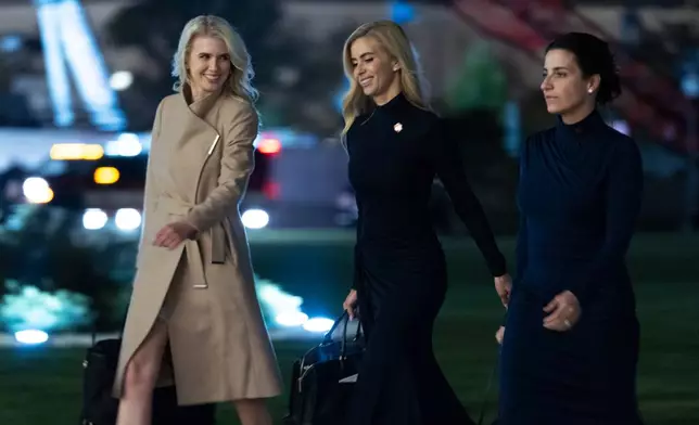 White House press secretary Katie Zacharia, center, White House aide Natalie Harp, left, and Danielle Alvarez, right, walk on the South Lawn as they arrive at the White House with President Donald Trump, early Thursday, Oct. 15, 2026, in Washington. (AP Photo/Manuel Balce Ceneta)