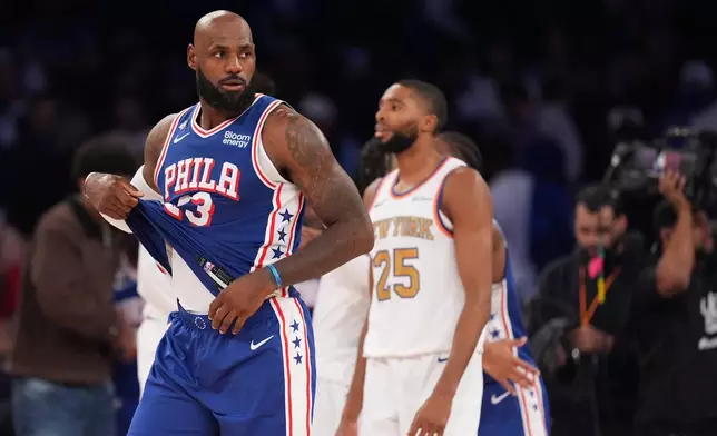 Philadelphia 76ers forward LeBron James, left, passes New York Knicks guard Mikal Bridges after the 76ers defeated the Knicks 106-100 in an NBA basketball game Tuesday, Oct. 20, 2026, in New York. (AP Photo/Frank Franklin II)