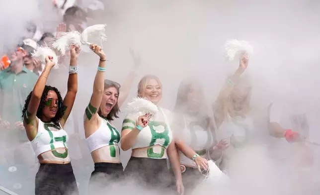 Miami fans cheer during the first half of an NCAA college football game against Pittsburgh, Saturday, Oct. 24, 2026, in Miami Gardens, Fla. (AP Photo/Rebecca Blackwell)