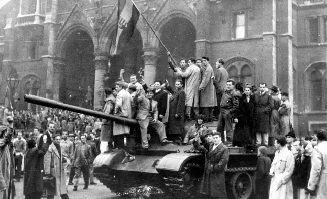 FILE - Hungarian rebels wave their red, white and green national flag from a tank captured in the main square of Budapest, Hungary, in 1956. (AP Photo/File)