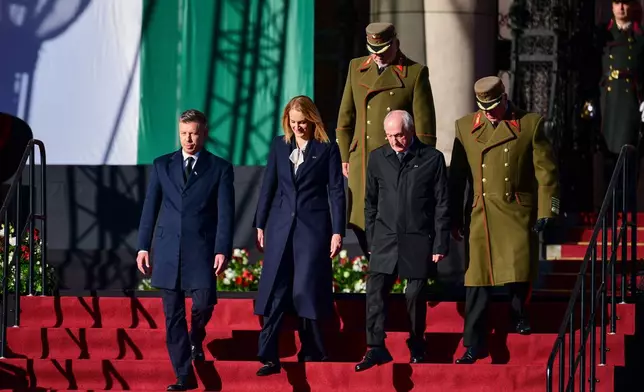 From left, Hungarian Prime Minister Peter Magyar, Agnes Forsthoffer, the Speaker of the National Assembly of Hungary and Hungary's President Andras Baka attend a flag-raising ceremony marking the 70th anniversary of the 1956 Hungarian Revolution against Soviet-backed communist rule in Budapest, Hungary, Friday, Oct. 23, 2026. (AP Photo/Pavel Bogolepov)