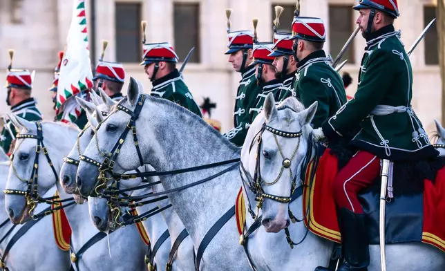 Honor guards attend a flag-raising ceremony marking the 70th anniversary of the 1956 Hungarian Revolution against Soviet-backed communist rule in Budapest, Hungary, Friday, Oct. 23, 2026. (AP Photo/Pavel Bogolepov)