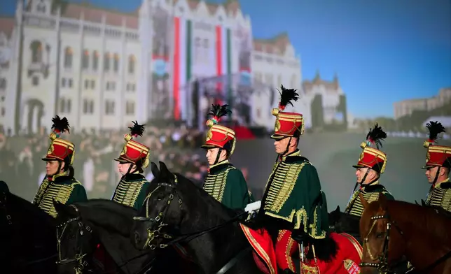 Honor guards attend a flag-raising ceremony marking the 70th anniversary of the 1956 Hungarian Revolution against Soviet-backed communist rule in Budapest, Hungary, Friday, Oct. 23, 2026. (AP Photo/Pavel Bogolepov)