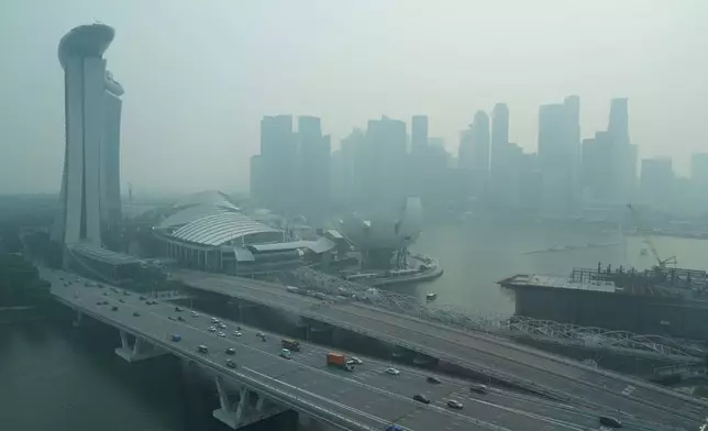 FILE - A thick haze obscures the skyline behind the Central Business District area in Singapore, Friday, Oct. 9, 2026. (AP Photo/David Hu, File)