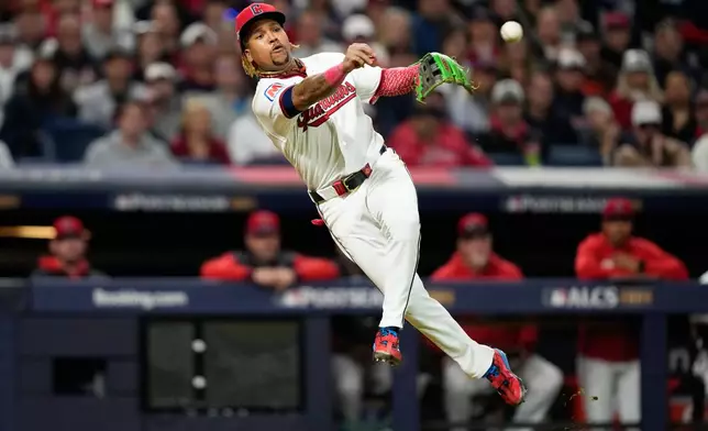 Cleveland Guardians third baseman José Ramírez throws out Tampa Bay Rays' Chandler Simpson at first during the eighth inning in Game 5 of an American League Championship Series baseball game in Cleveland, Sunday, Oct. 18, 2026. (AP Photo/David J. Phillip)