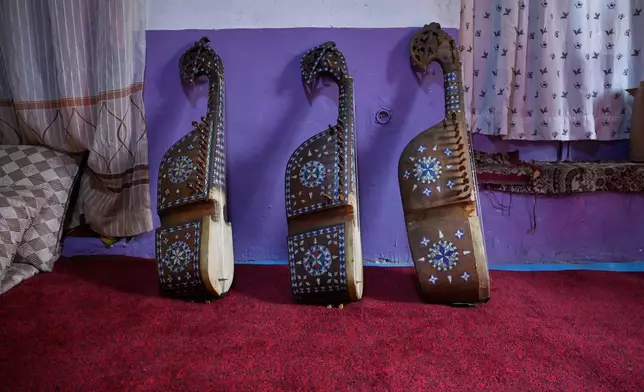 Rubabs, traditional stringed instruments belonging to a former music teacher who closed his family's instrument shop following the Taliban takeover in 2021, lean against a wall in Kabul, Afghanistan. Sunday, Oct.11, 2026.(AP Photo/Nava Jamshidi)