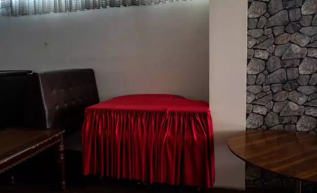 FILE - Red cloth covers a grand piano in a hookah bar in Kabul, Afghanistan, Sept. 21, 2021. (AP Photo/Bernat Armangue, File)