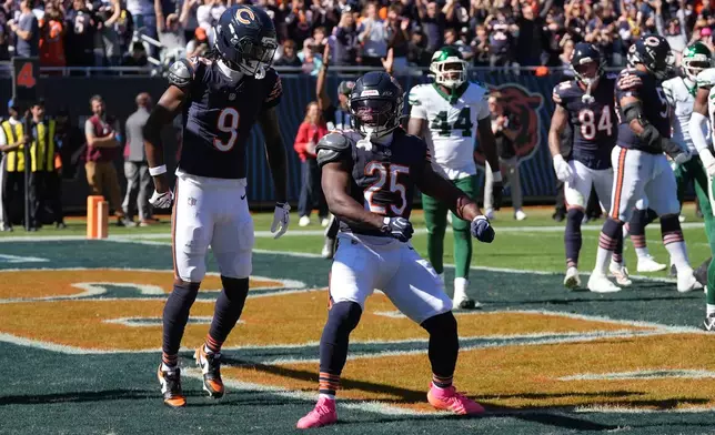 Chicago Bears running back Kyle Monangai (25) celebrates after scoring as teammate Jahdae Walker (9) watches during the first half of an NFL football game against the New York Jets Sunday, Oct. 4, 2026, in Chicago. (AP Photo/David Banks)