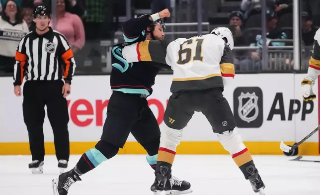 Seattle Kraken defenseman Brandon Montour, left, fights with Vegas Golden Knights right wing Mark Stone (61) during the third period of an NHL hockey game, Tuesday, Oct. 6, 2026, in Seattle. (AP Photo/Lindsey Wasson)