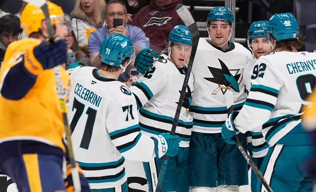 San Jose Sharks center Will Smith (2) celebrates his goal with teammates during the third period of an NHL hockey game against the Nashville Predators, Thursday, Oct. 15, 2026, in Nashville, Tenn. (AP Photo/George Walker IV)