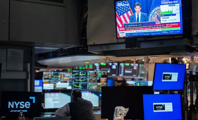 A screen displays a news conference by Federal Reserve Board Chairman Kevin Warsh on the floor of the New York Stock Exchange, Wednesday, Oct. 28, 2026, in New York. (AP Photo/Yuki Iwamura)