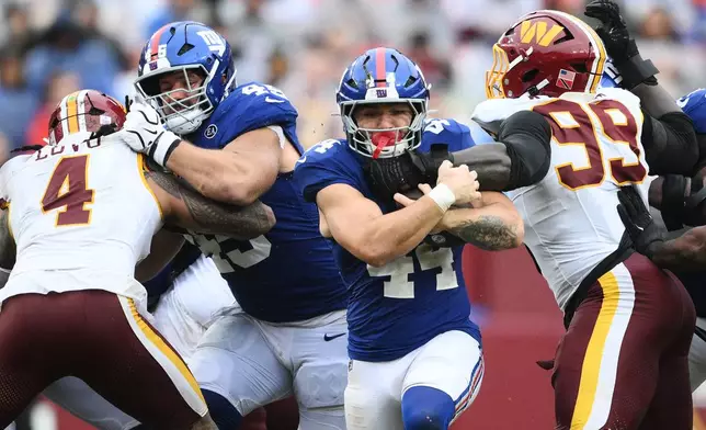 FILE - New York Giants' Cam Skattebo (44) rushes during the second half of an NFL football game against the Washington Commanders in Landover, Md., Oct. 11, 2026. (AP Photo/Nick Wass, File)