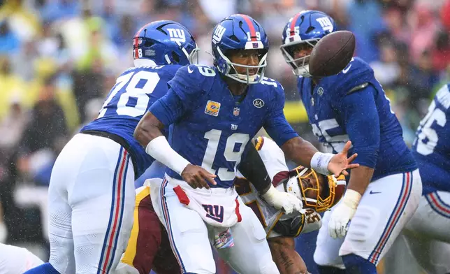New York Giants quarterback Jameis Winston (19) fumbles the ball during the first half of an NFL football game against the Washington Commanders in Landover, Md., Sunday, Oct. 11, 2026. (AP Photo/Nick Wass)