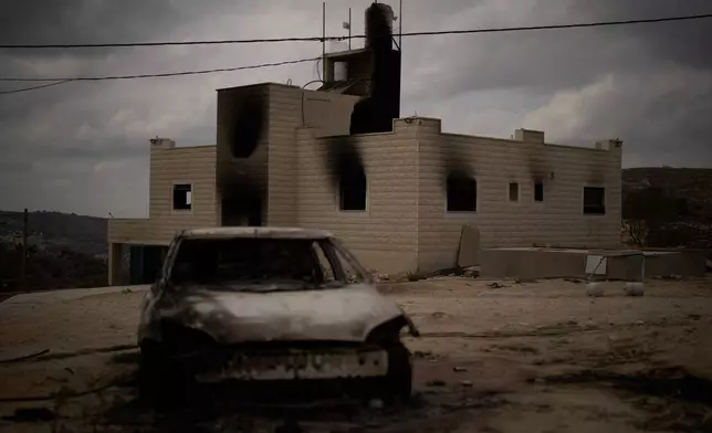 FILE - A burnt car is seen in front of one of the two Palestinian houses belonging to the Tubasi family, which were burned in the West Bank village of Jalud, Sept. 29, 2026, following an overnight attack by Israeli settlers. (AP Photo/Leo Correa, File)
