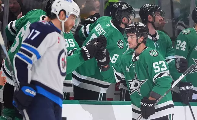 Dallas Stars center Wyatt Johnston (53) is congratulated after scoring against the Winnipeg Jets during the second period of an NHL hockey game Thursday, Oct. 22, 2026, in Dallas. (AP Photo/LM Otero)
