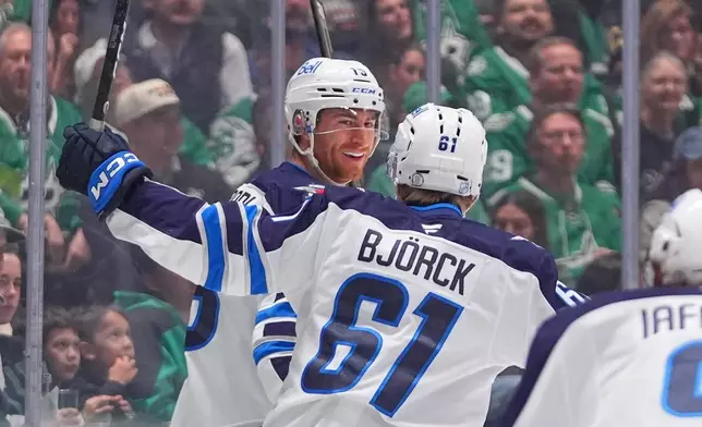 Winnipeg Jets center Gabriel Vilardi, left, celebrates after scoring with teammate center Viggo Bjorck (61) during the second period of an NHL hockey game against the Dallas Stars, Thursday, Oct. 22, 2026, in Dallas. (AP Photo/LM Otero)