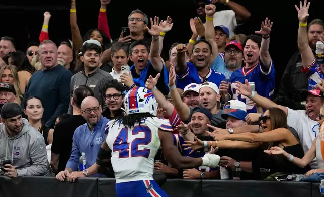 Buffalo Bills linebacker Dorian Williams (42) celebrates with fans after an interception against the Las Vegas Raiders during the second half of an NFL football game in Las Vegas, Sunday, Oct. 18, 2026. (AP Photo/John Locher)