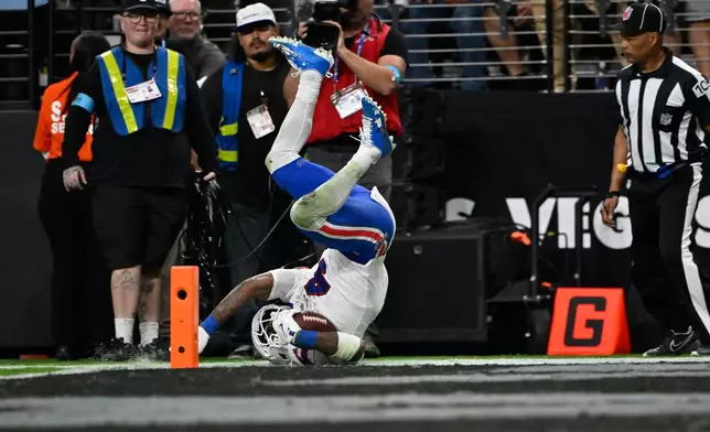 Buffalo Bills running back James Cook III (4) is flipped out of bounds just short of the goal line during the second half of an NFL football game against the Las Vegas Raiders in Las Vegas, Sunday, Oct. 18, 2026. (AP Photo/David Becker)