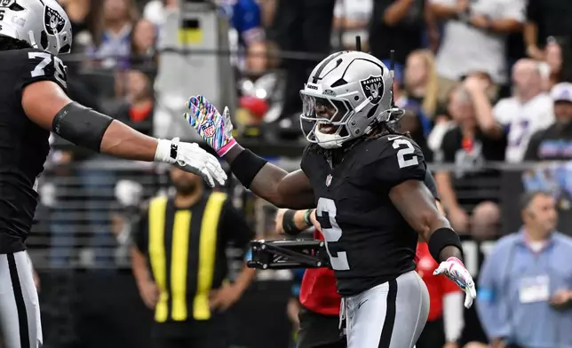 Las Vegas Raiders running back Ashton Jeanty (2) celebrates his touchdown against the Buffalo Bills during an NFL football game in Las Vegas, Sunday, Oct. 18, 2026. (AP Photo/David Becker)
